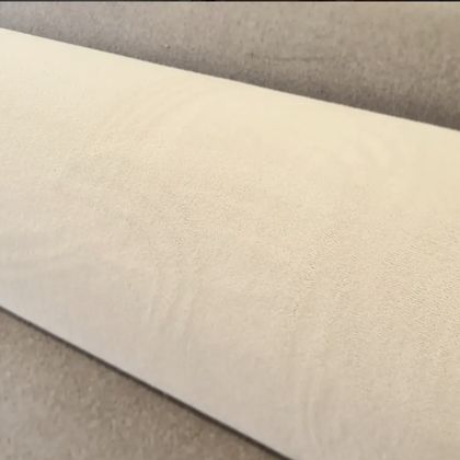 Close-up of a roll of cream wool carpet