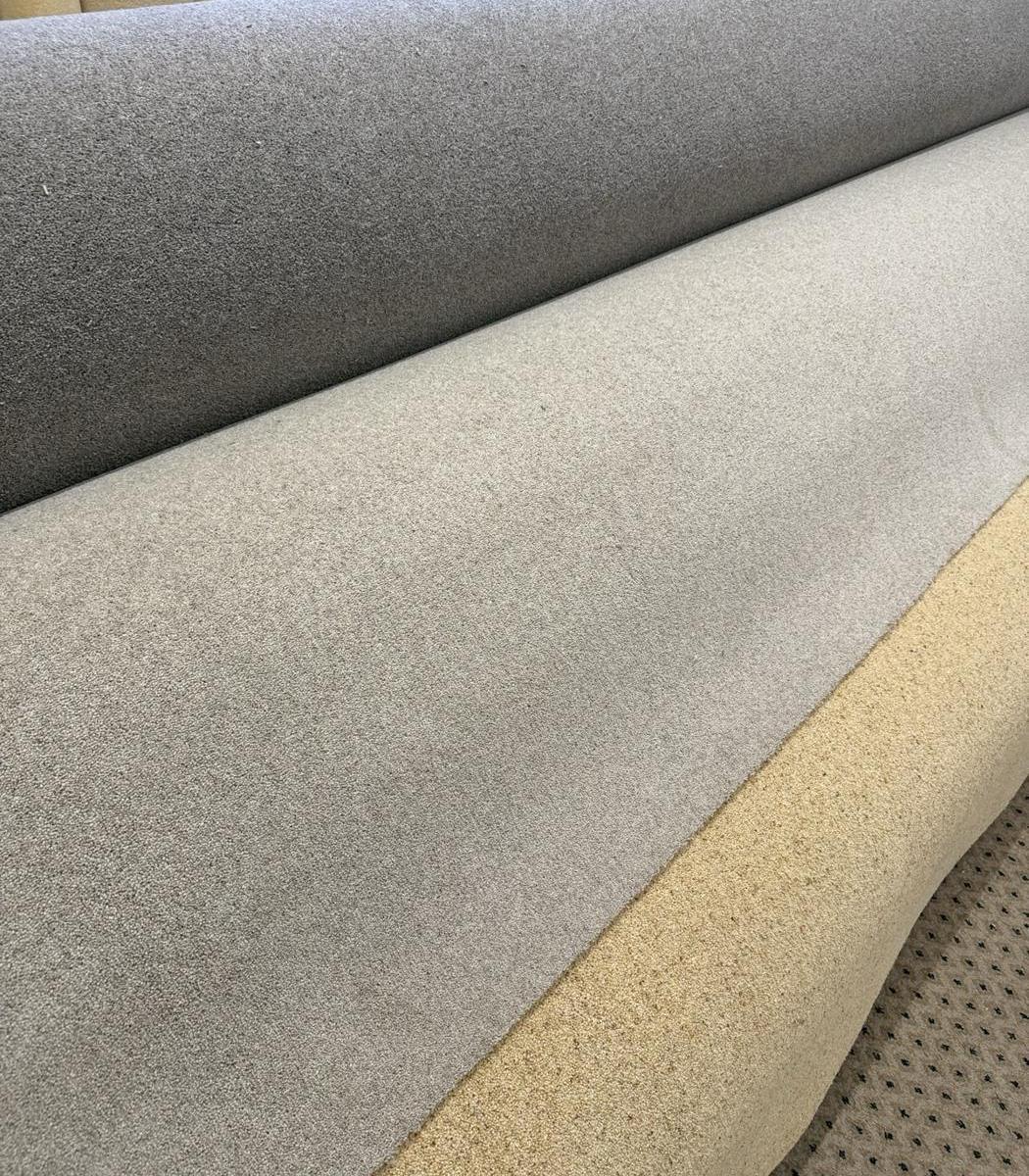 Close-up of grey and oatmeal carpet rolls