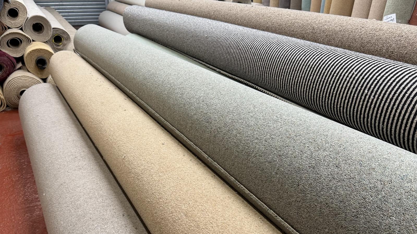 Rolls of plain, striped and heather carpet in the showroom