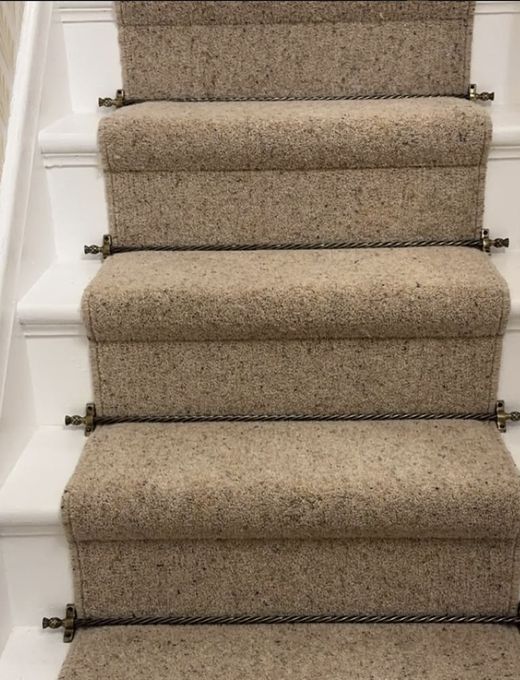 Wool stair runner fitted with brass stair rods